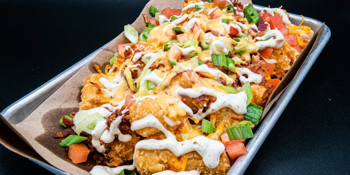 Perfect SZN loaded nachos with cheese, scallions and sour cream